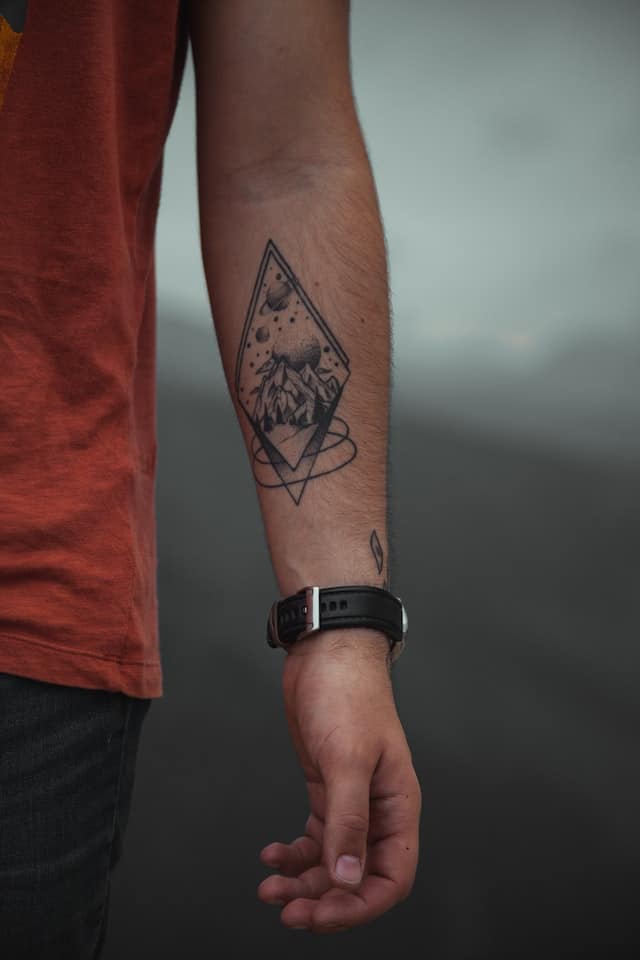 space forearm tattoo